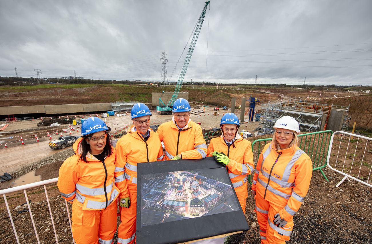Maggie Grogan, Stuart Croft, Ian Courts, Andy Street and Ailsa Waygood in high-vis jumpsuits and hardhats at the Arden Cross site