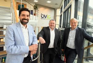 From left: Lee De Souza from Harrison Bridge, Andy Stewart the Centre Manager at Blythe Valley Innovation Centre and Cllr Ian Courts Leader of Solihull Council at Blythe Valley Innovation Centre posing for a photo by some stairs.