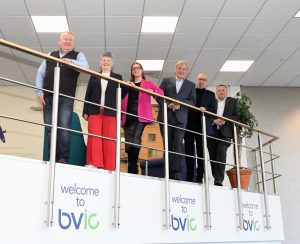From left: Robert Proudfoot, Julie Malone, Sophie Malone (all Parklea Projects), Cllr Ian Courts (Leader of Solihull Council), Paul Malone (Founder of Parklea Projects), Andy Stewart (Centre Manager at Blythe Valley Innovation Centre) stand on a higher floor looking over a banister.